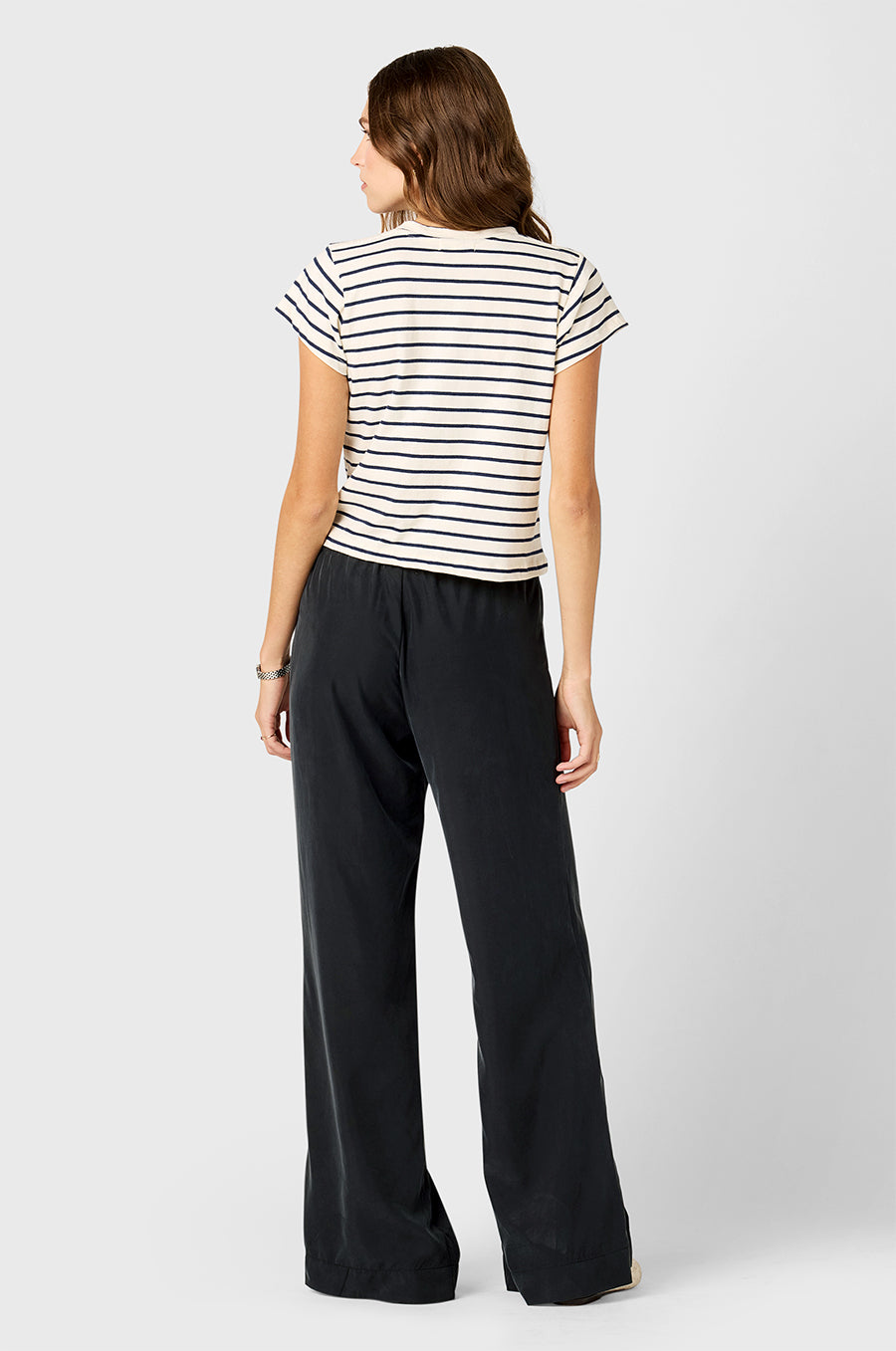 Model wearing The Lady & The Sailor Shrunken BF Tee in Navy Stripe and Silky Wide Leg Pant in Washed Black.
