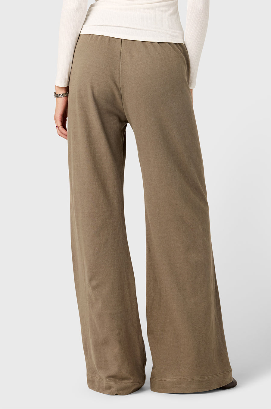 Model wearing The Lady & The Sailor Wide Leg Pant in Morel - a army brown colored mid-rise wide leg sweatpant.