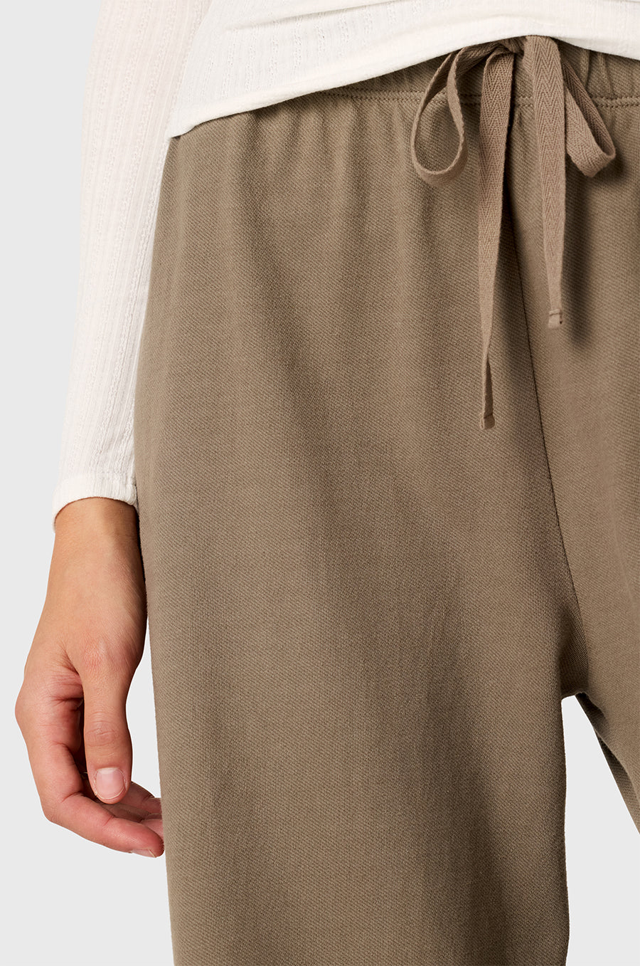 Model wearing The Lady & The Sailor Wide Leg Pant in Morel - a army brown colored mid-rise wide leg sweatpant.