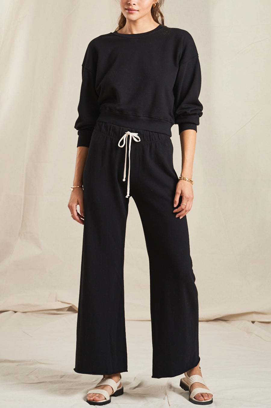 Model wearing the lady & the sailor French Flare Pant in Black Organic Cotton.
