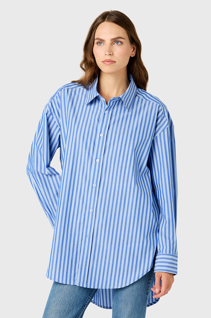 Model wearing The Lady & The Sailor Curved Hem Button up in French Blue Stripe.