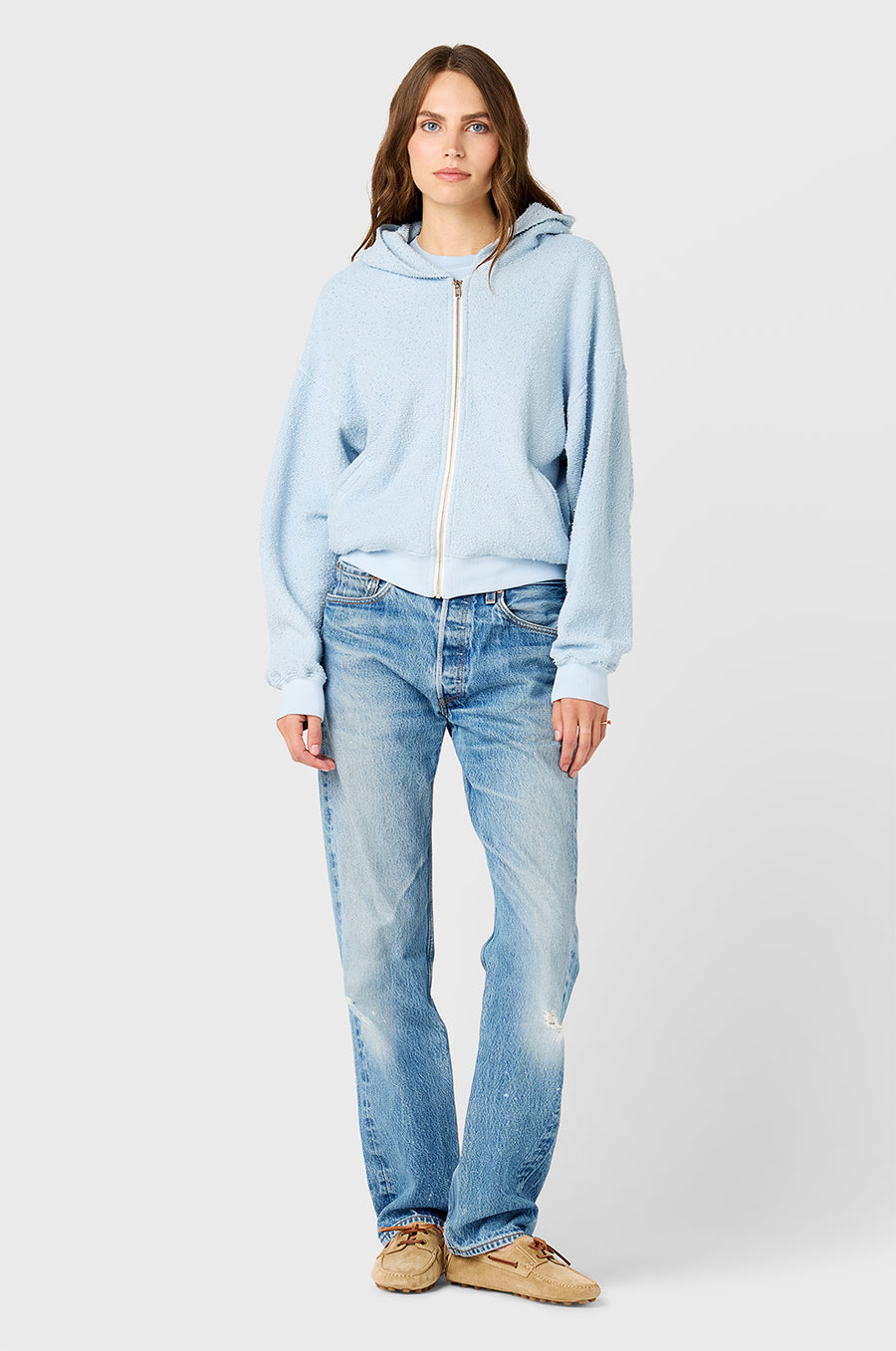 Model wearing The Lady & The Sailor Zip Up Hoodie in Powdery Blue Bouclé.