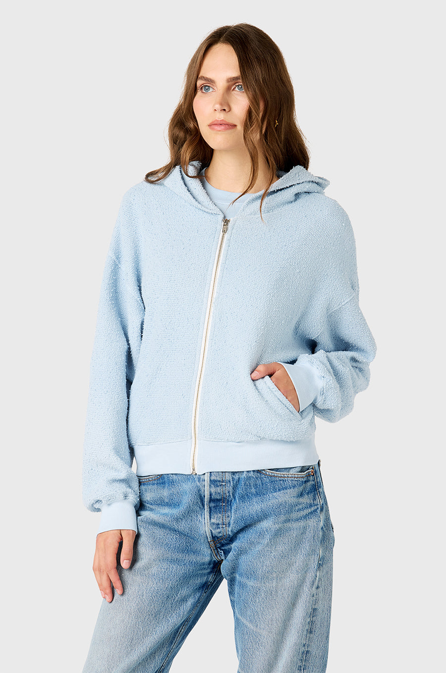 Model wearing The Lady & The Sailor Zip Up Hoodie in Powdery Blue Bouclé.