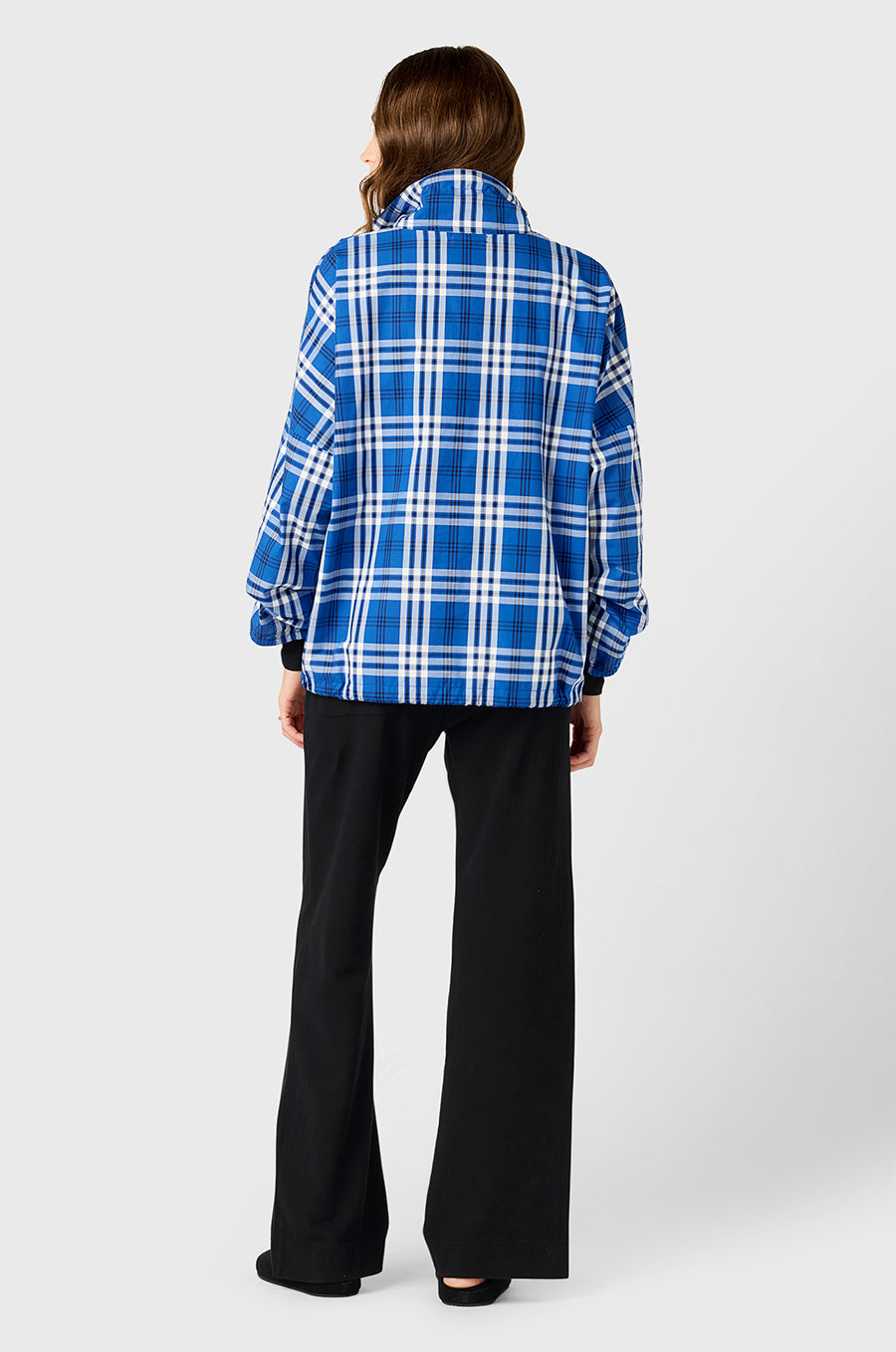 Model wearing The Lady & The Sailor Anorak in Royal Blue Plaid - a quarter zip anorak with a tall collar and relaxed fit, the Long Sleeve Classic Tee in Black Classic Rib, and the Pocket Straight Leg Pant in Black Cotton Twill.