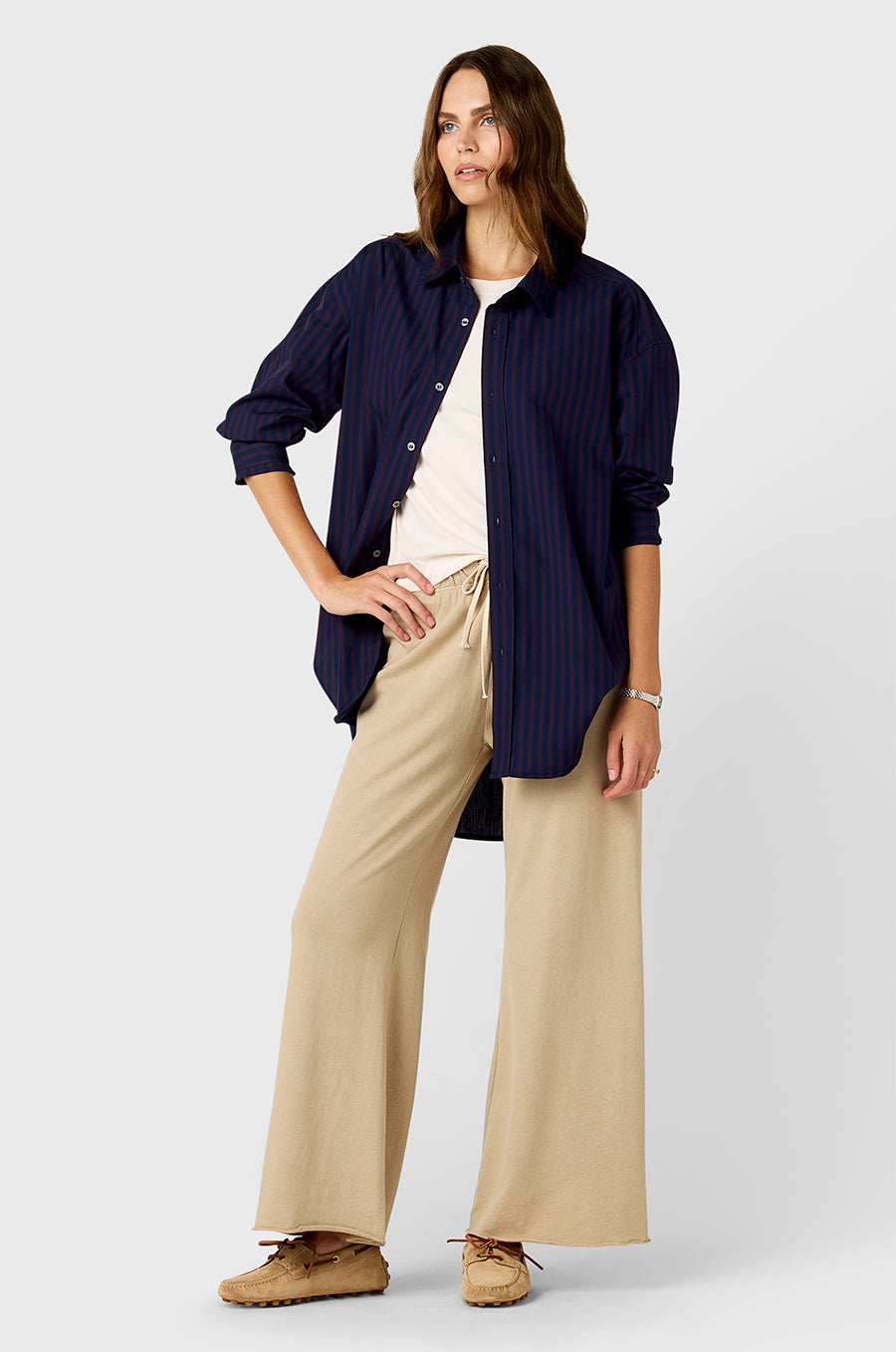 Model wearing The Lady & The Sailor Curved Hem Button up in Navy and Burgundy Stripe and French Flare Pant in Sable Organic Cotton.