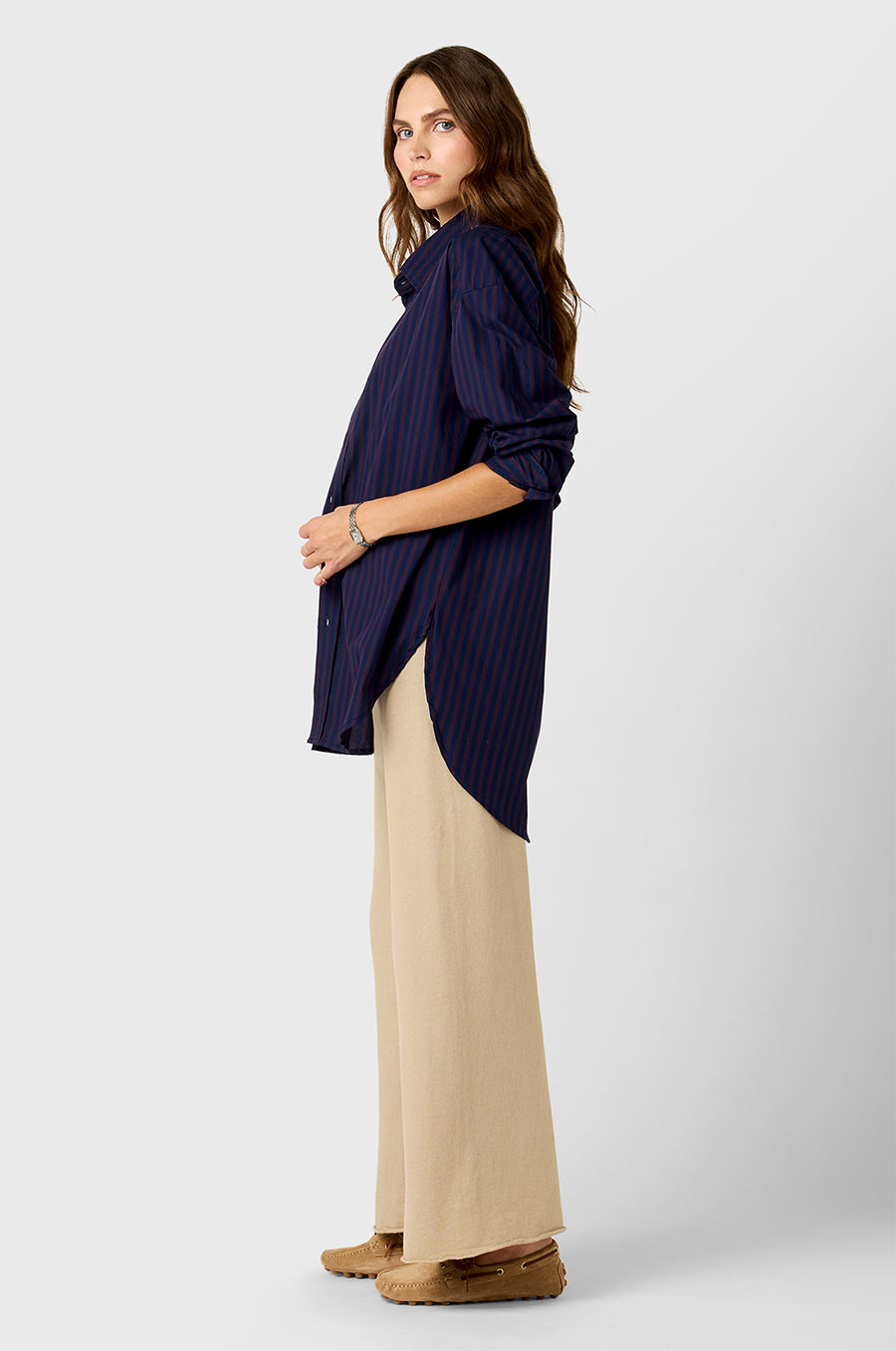 Model wearing The Lady & The Sailor Curved Hem Button up in Navy and Burgundy Stripe and French Flare Pant in Sable Organic Cotton.