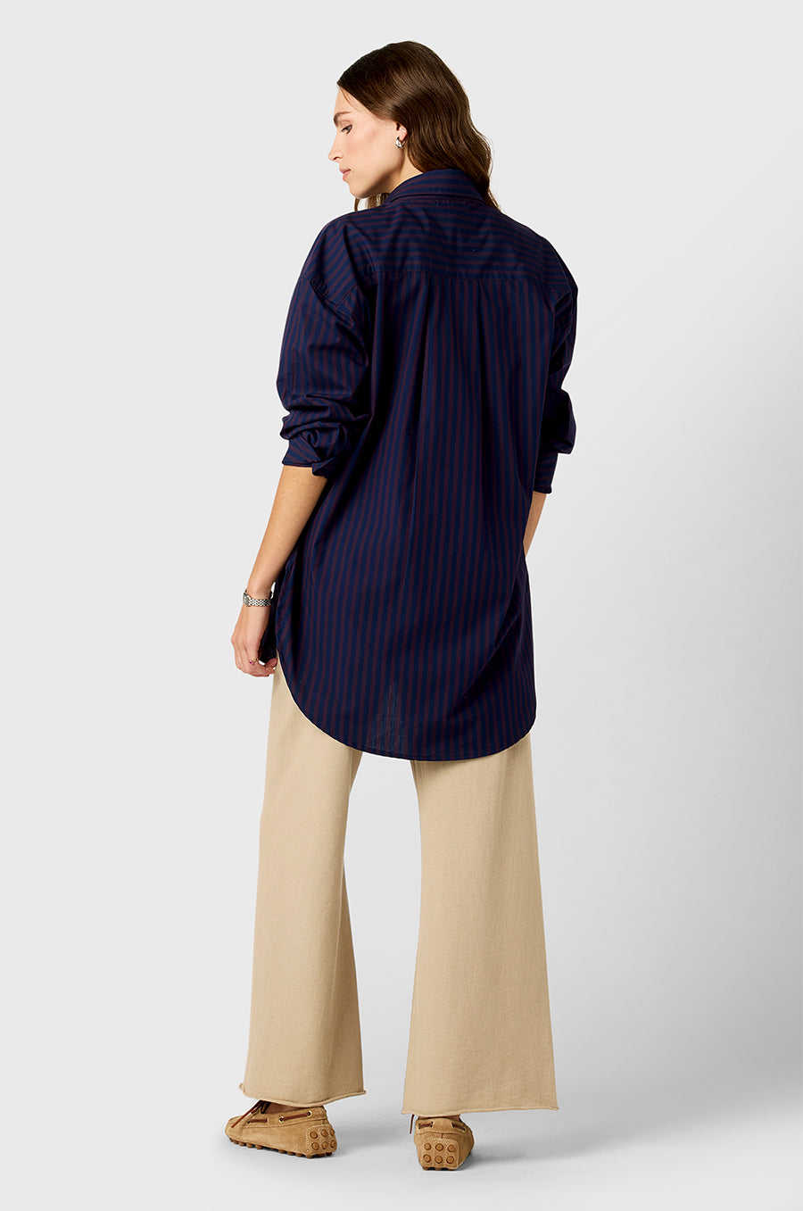 Model wearing The Lady & The Sailor Curved Hem Button up in Navy and Burgundy Stripe and French Flare Pant in Sable Organic Cotton.