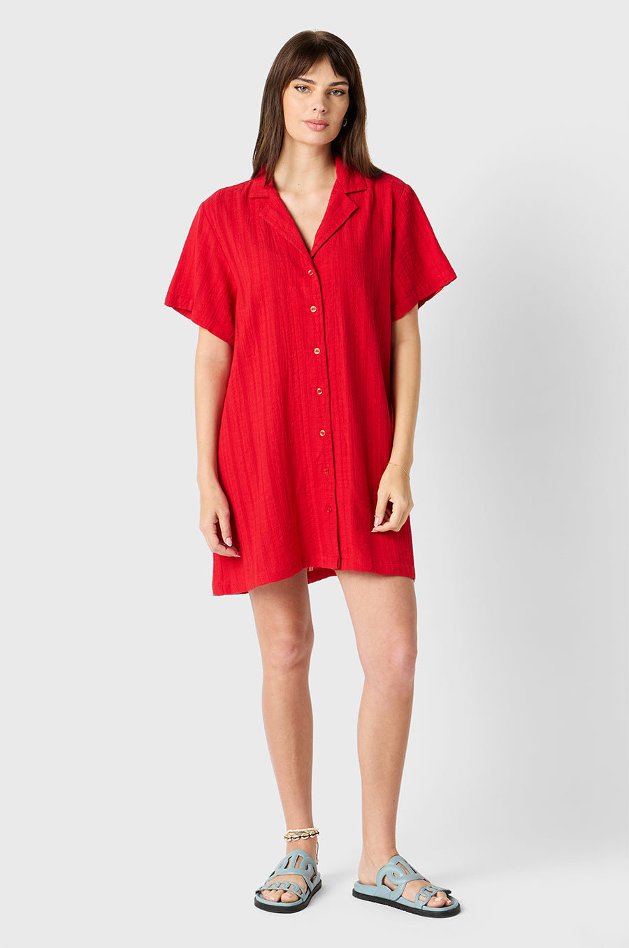 Brunette model wearing the lady & the sailor Button Up Mini Dress in Red Beach Stripe