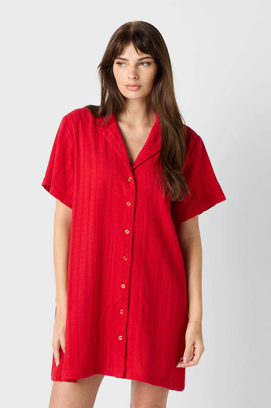 Brunette model wearing the lady & the sailor Button Up Mini Dress in Red Beach Stripe