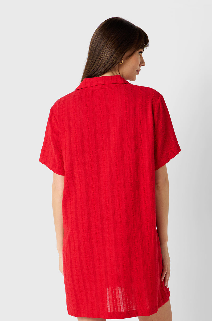 Brunette model wearing the lady & the sailor Button Up Mini Dress in Red Beach Stripe