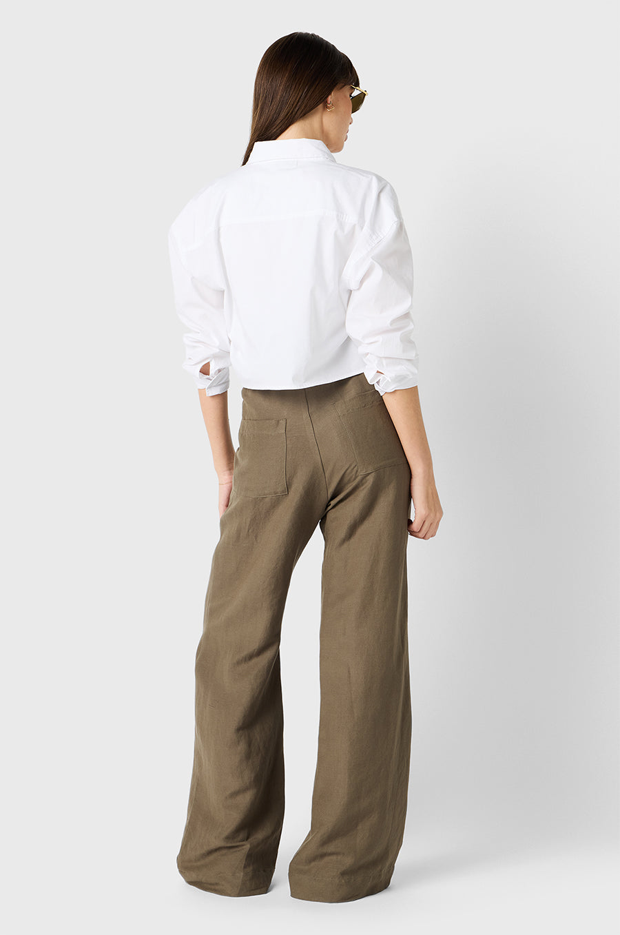 Brunette model wearing the lady & the sailor Cropped Button Up in White Poplin.