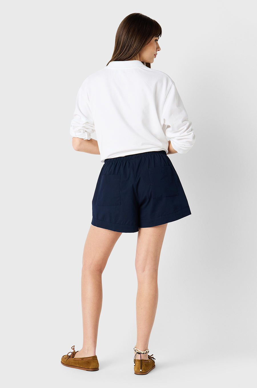 Brunette Model wearing the lady & the sailor Cuffed Short in Navy Poplin