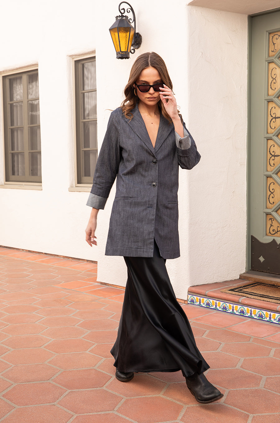 Model wearing the lady & the sailor the Relaxed Blazer in Dark Denim Stripe.