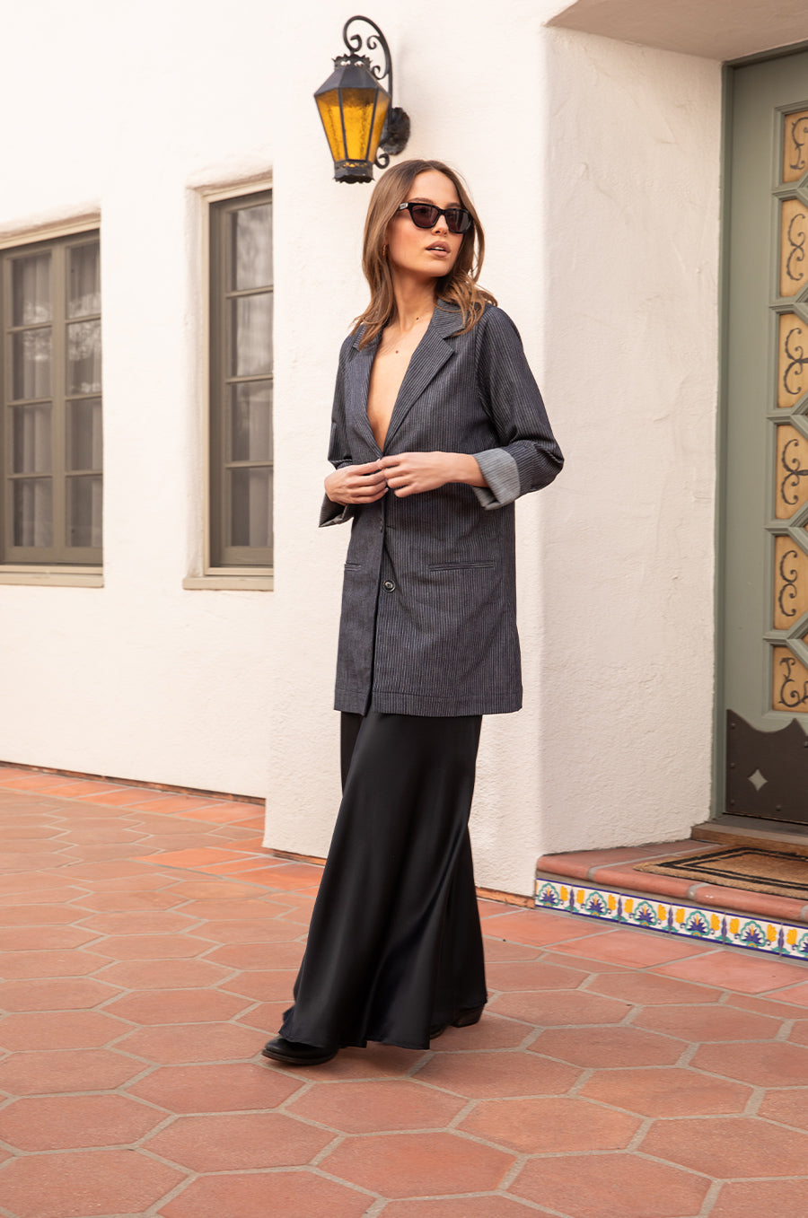 Model wearing the lady & the sailor the Relaxed Blazer in Dark Denim Stripe.