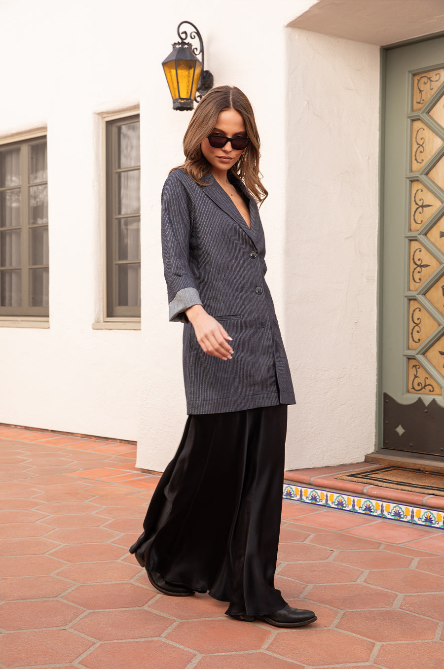 Model wearing the lady & the sailor the Relaxed Blazer in Dark Denim Stripe.