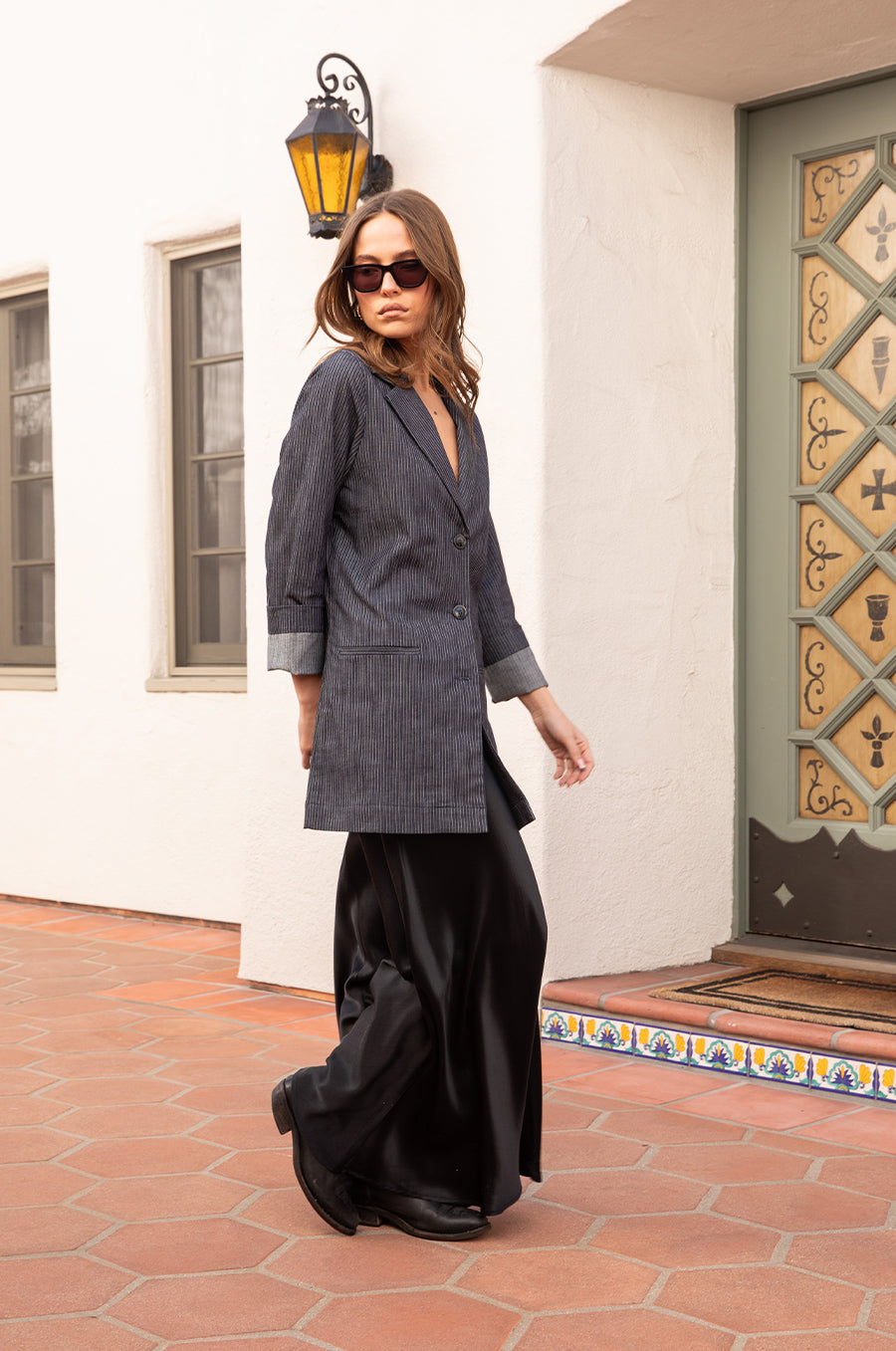 Model wearing the lady & the sailor the Relaxed Blazer in Dark Denim Stripe.
