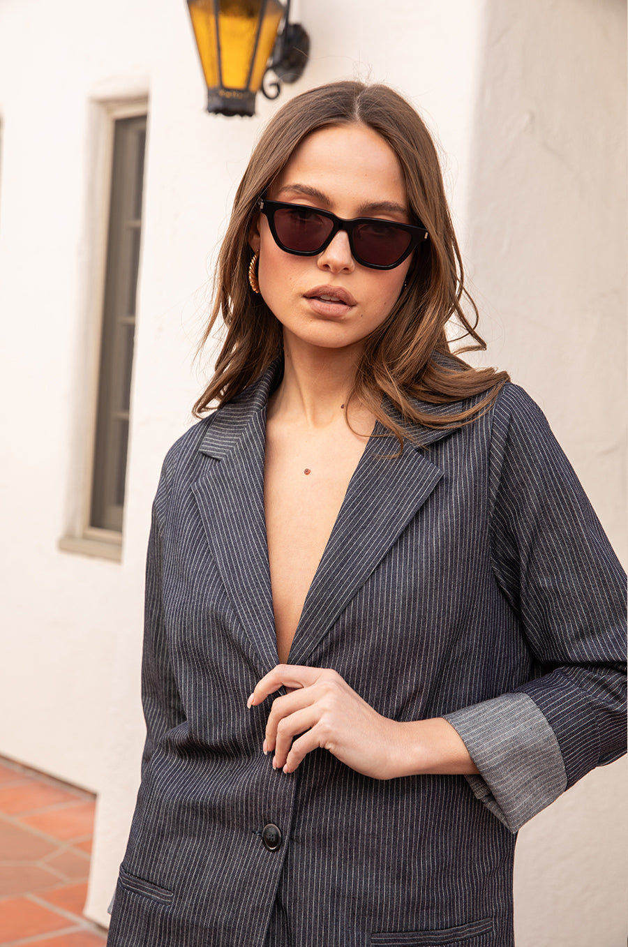 Model wearing the lady & the sailor the Relaxed Blazer in Dark Denim Stripe.