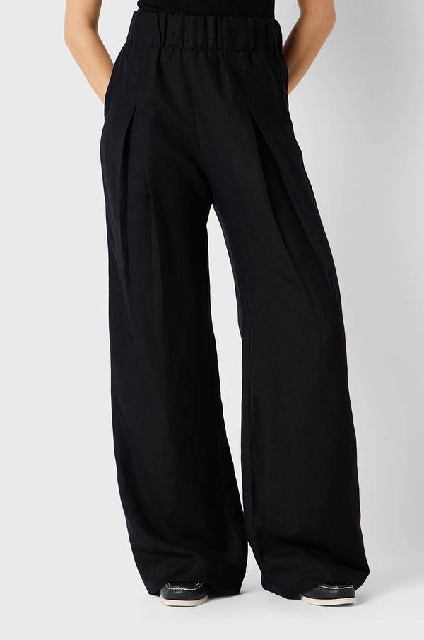 Brunette Model wearing the lady & the sailor Pleated Trouser in Black