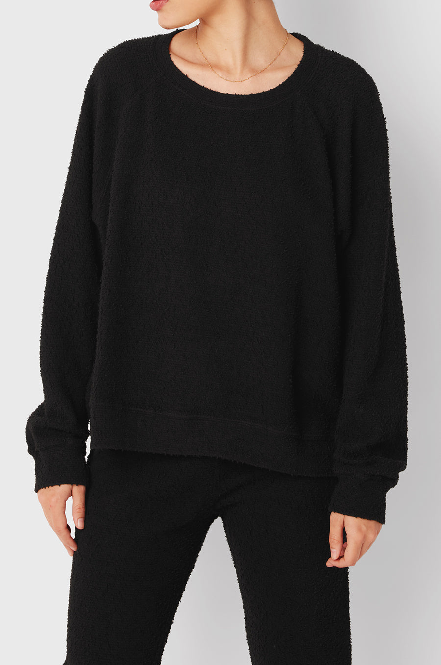 Brunette Model wearing the lady & the sailor Brentwood Sweatshirt in Black Bouclé.