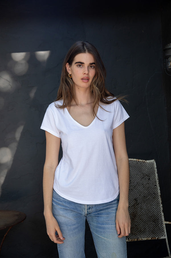 Brunette Model wearing the lady & the sailor V Neck Tee in White Organic Cotton.