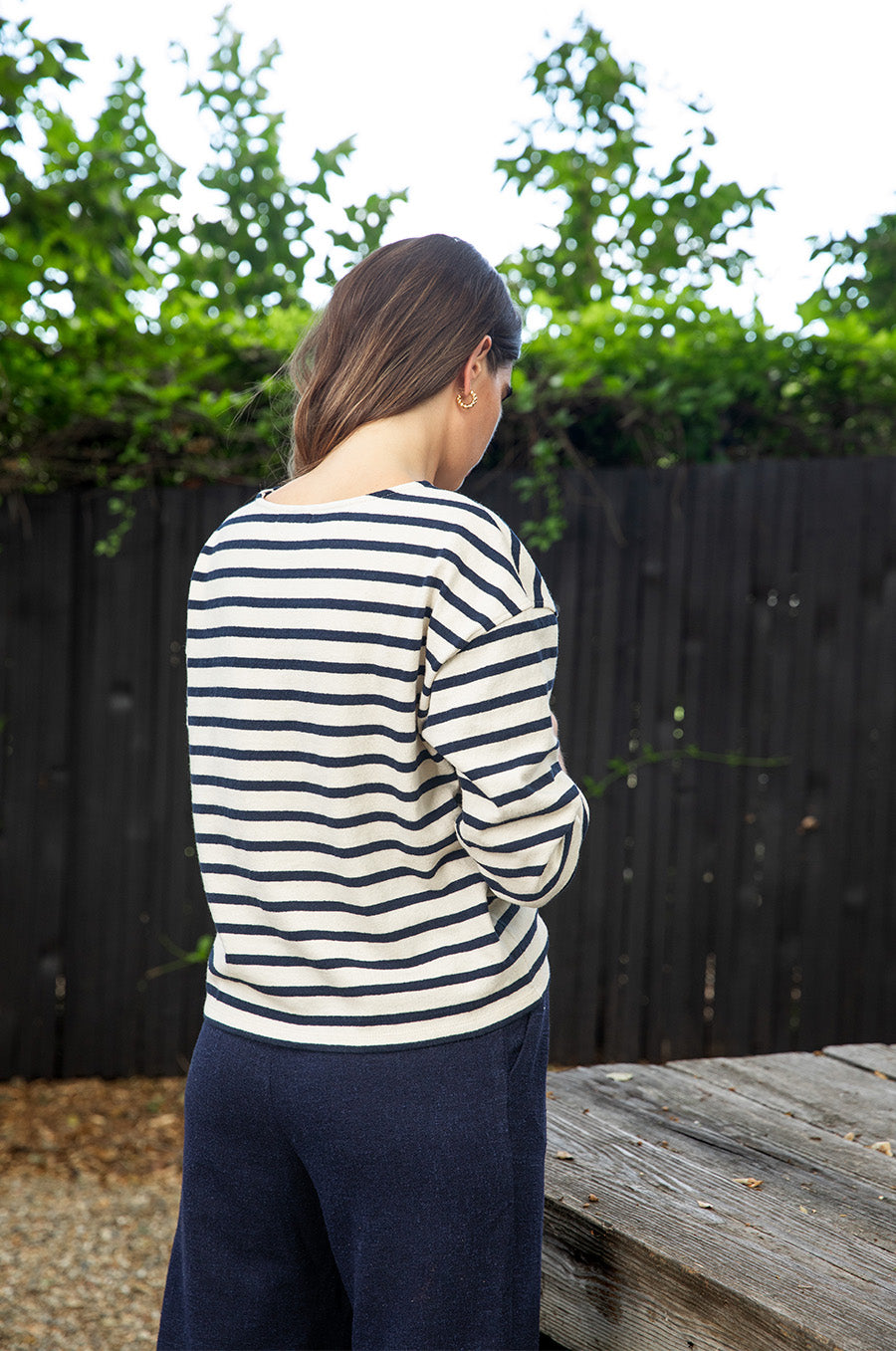Brunette model wearing the lady & the sailor Boxy Pullover in Navy Stripe.