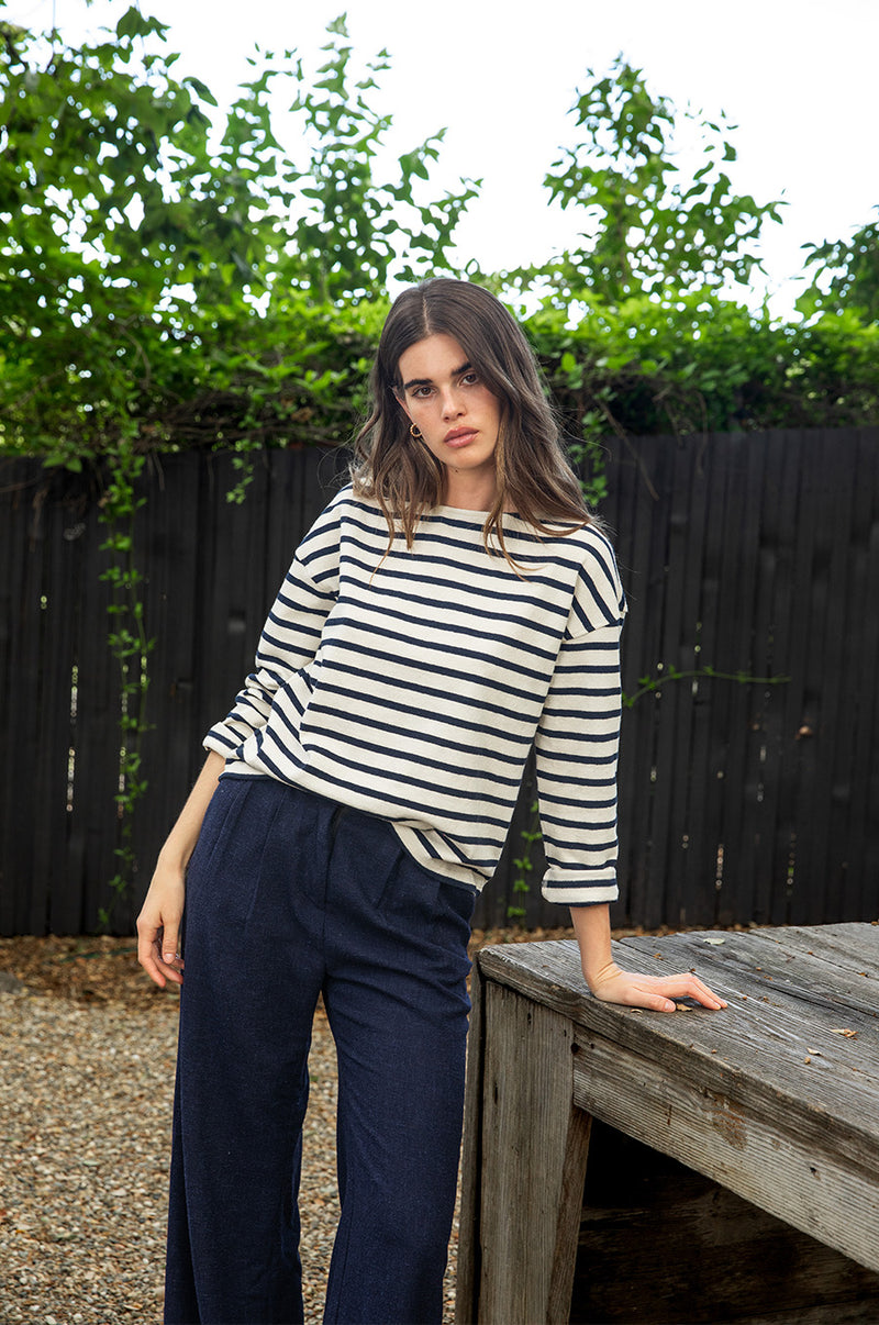 Brunette model wearing the lady & the sailor Boxy Pullover in Navy Stripe.