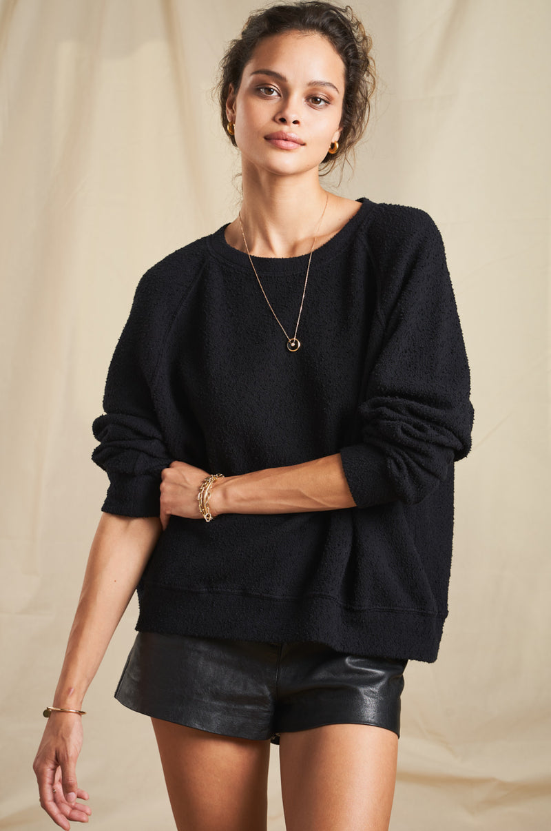 Model wearing the lady & the sailor Brentwood Sweatshirt in Black Boucle.