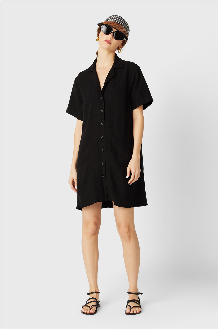 Brunette Model wearing the lady & the sailor the Button Up Mini Dress in Black.