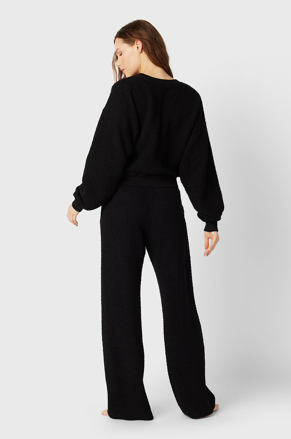 Brunette Model wearing the lady & the sailor the Straight Leg Sweatpant in Black Boucle.