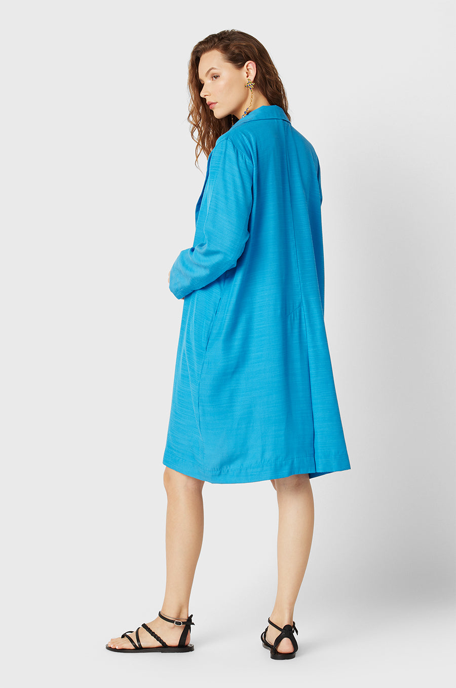 Brunette Model wearing the lady & the sailor Midi Blazer in Turquoise.