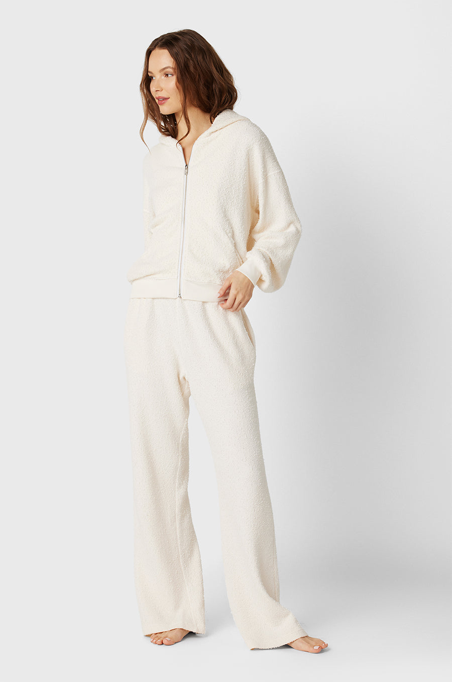 Brunette Model wearing the lady & the sailor the Zip Up Hoodie in Vanilla Boucle.