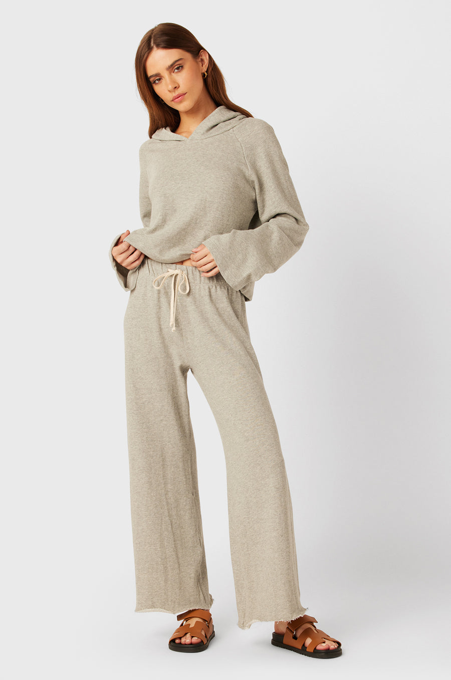 Brunette Model wearing the lady & the sailor French Flare Pant in Heather Grey Organic Cotton.