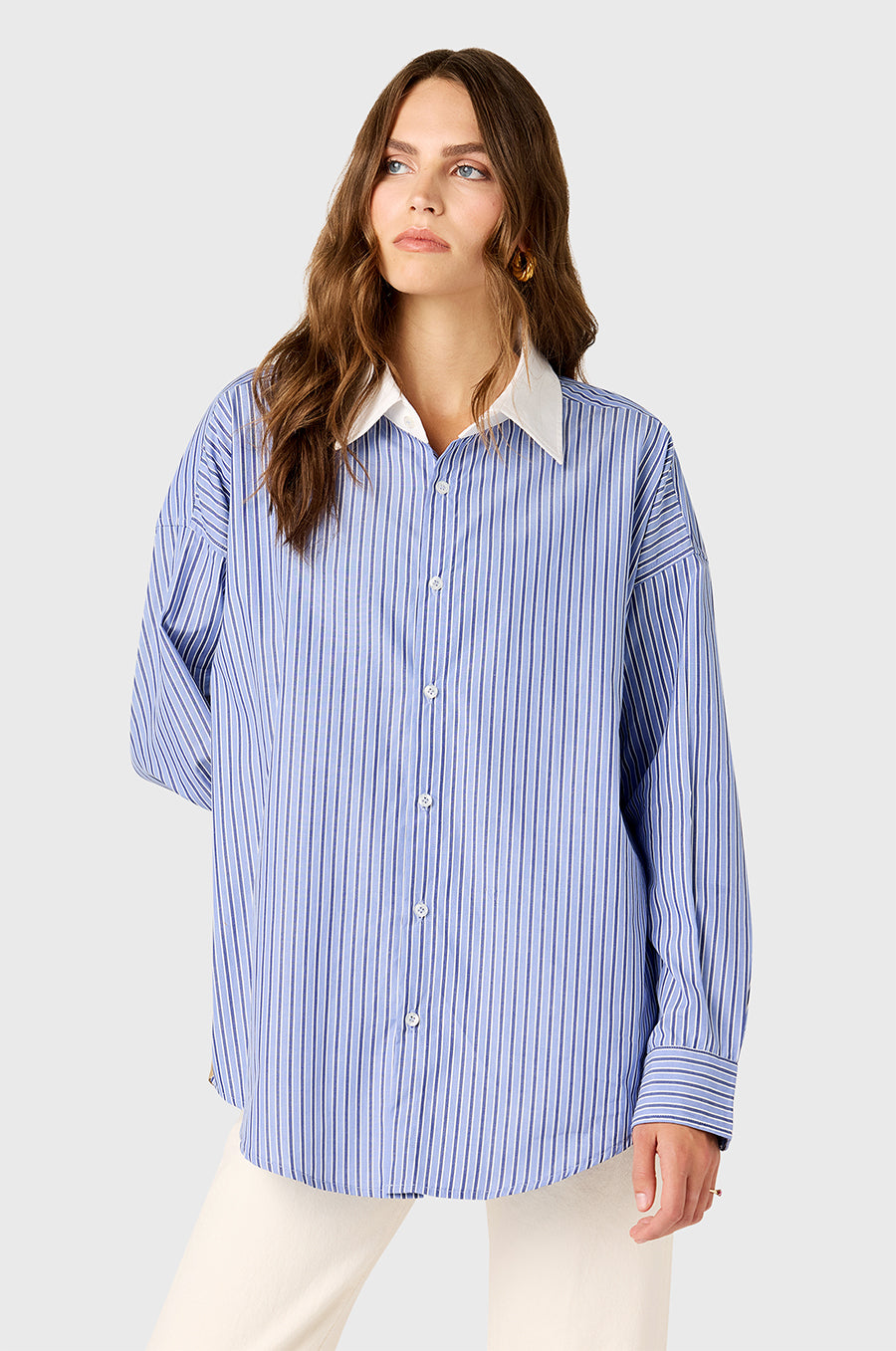 Model wearing the lady & the sailor Colorblocked Sunday Shirt in Khaki/Blue Stripe.