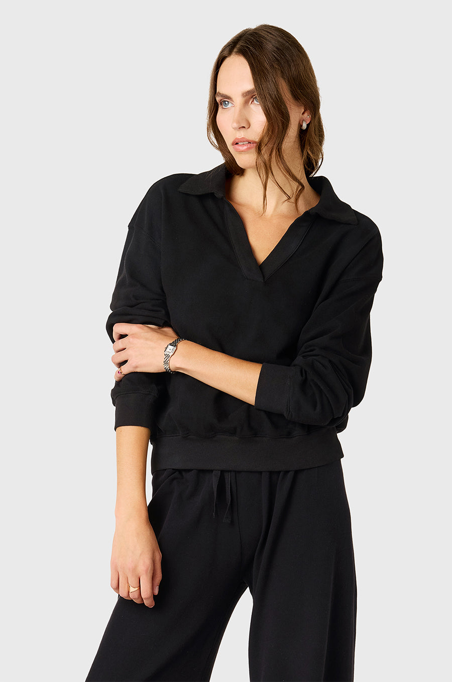 Model wearing The Lady & The Sailor Polo Sweatshirt in Black Cotton Twill and Wide Leg Pant in Black - a mid-rise wide leg sweatpant.