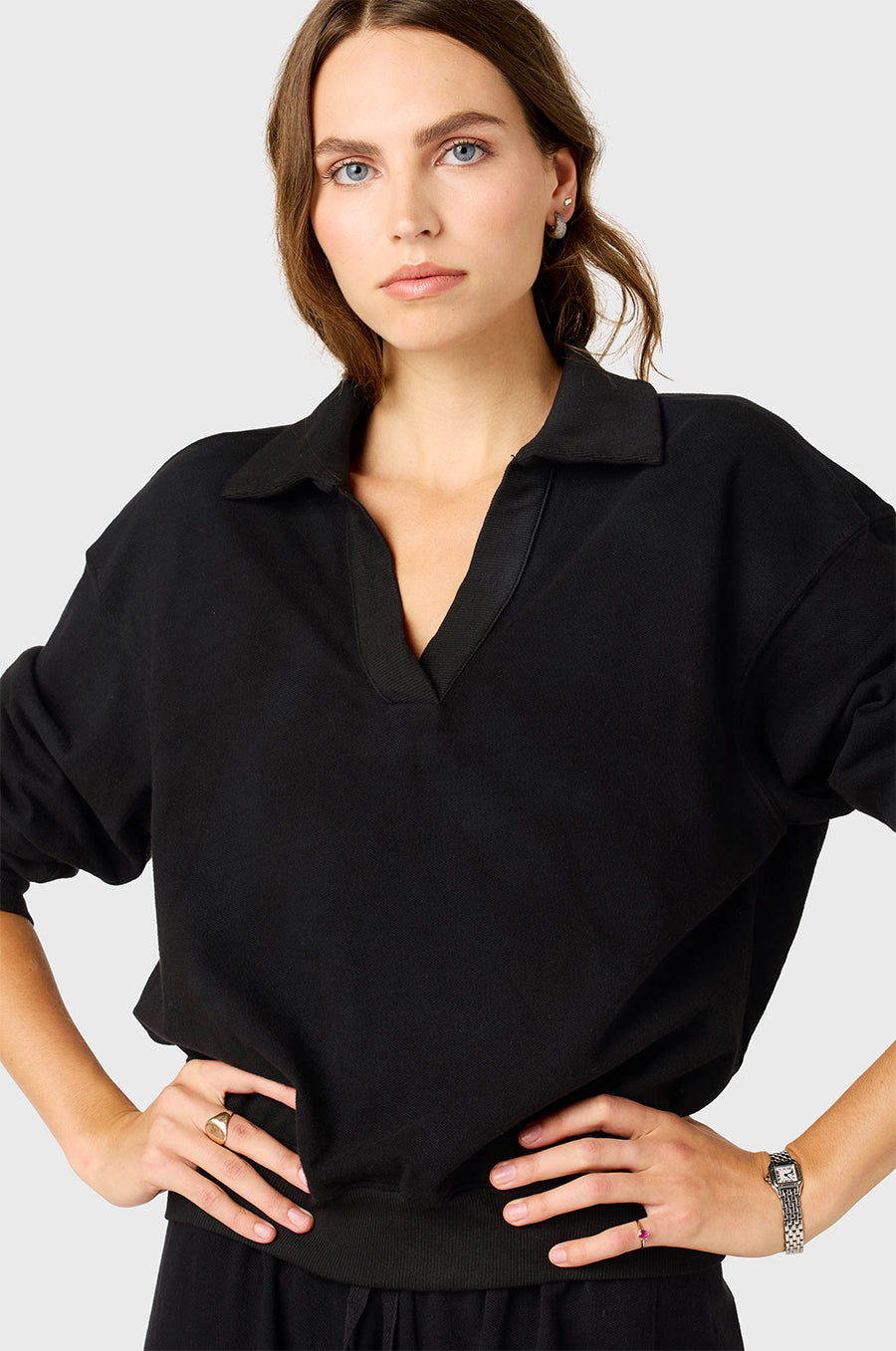 Model wearing the lady & the sailor Polo Sweatshirt in Black Cotton Twill.