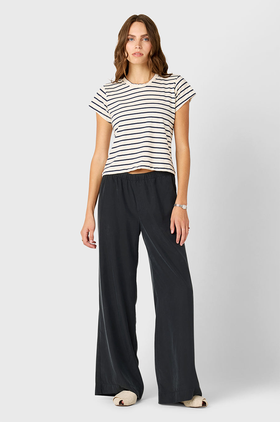 Model wearing The Lady & The Sailor Shrunken BF Tee in Navy Stripe and Silky Wide Leg Pant in Washed Black.