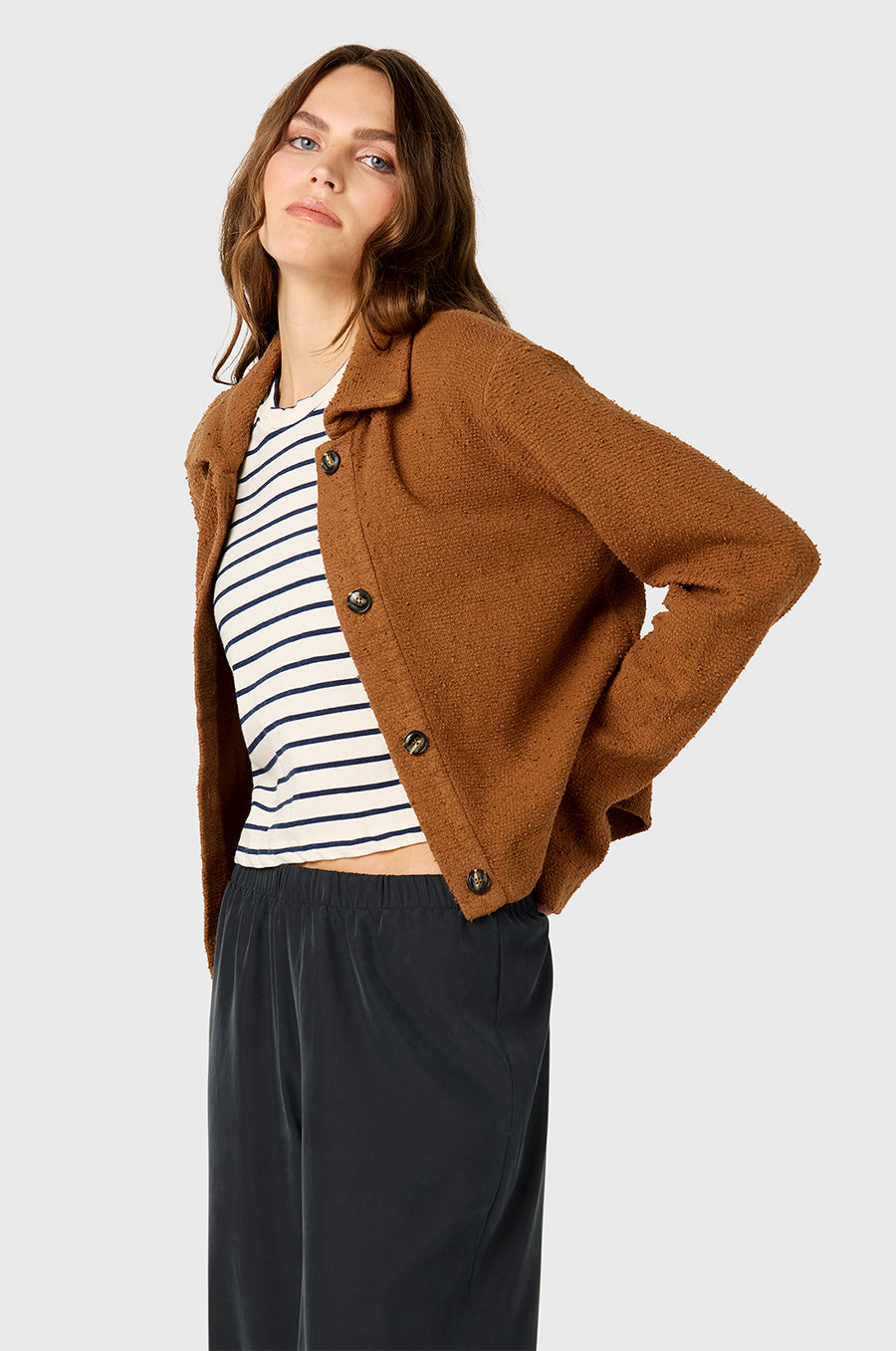 Model wearing The Lady & The Sailor Collared Cardi in Praline Bouclé, Shrunken BF Tee in Navy Stripe, and Silky Wide Leg Pant in Washed Black.