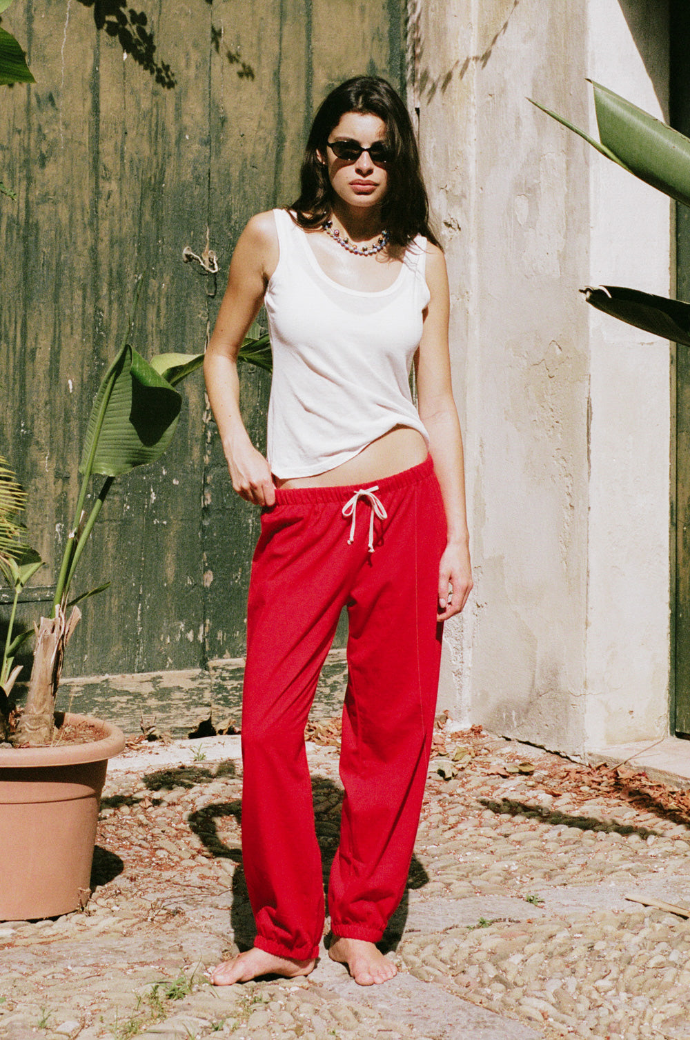 the relaxed sweatpant in red jersey styled with the feather scoop tank in white sheer cotton - the lady & the sailor