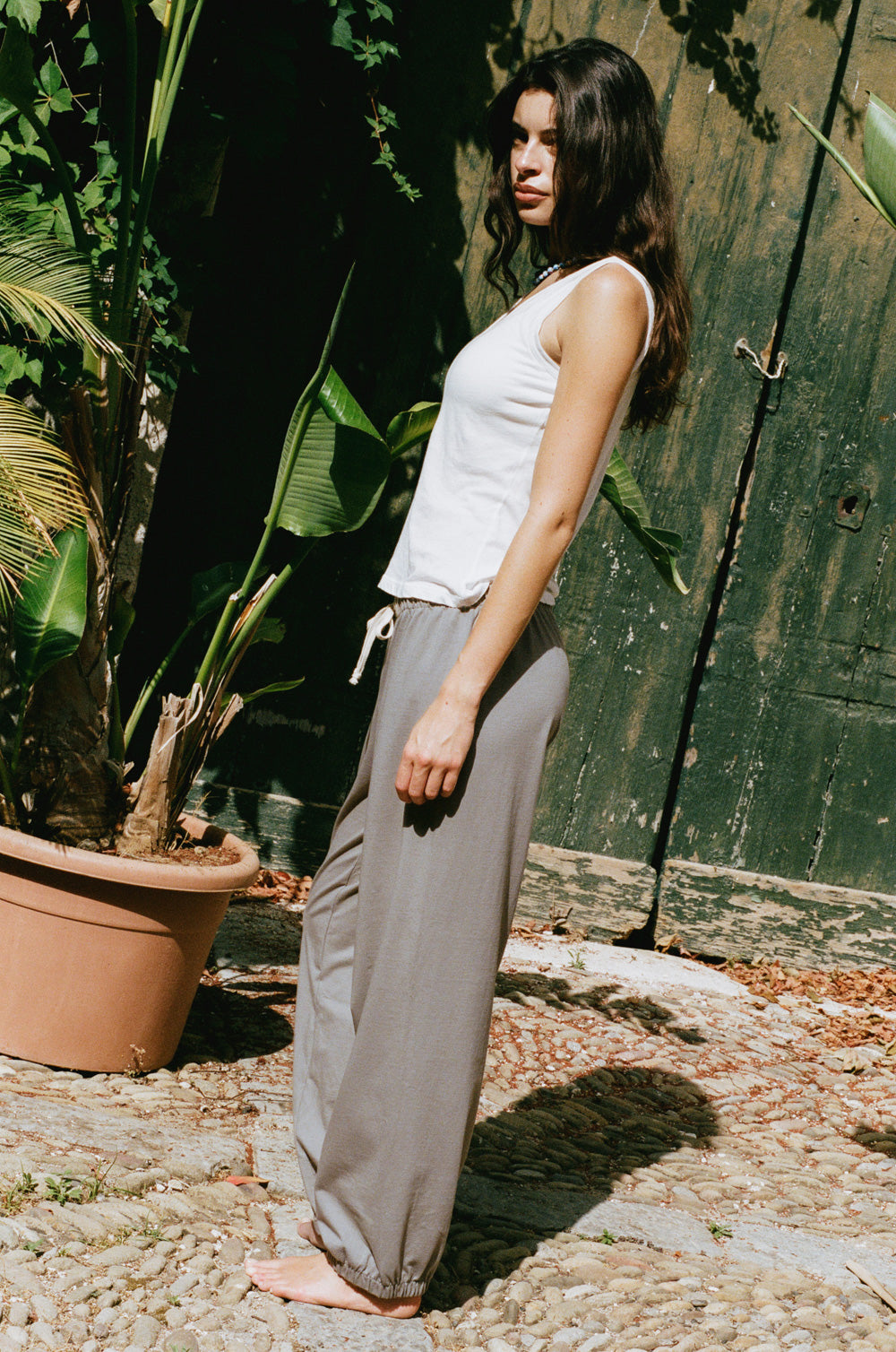 Relaxed sweatpant in taupe jersey styled with the feather scoop tank in white sheer cotton -  the lady & the sailor