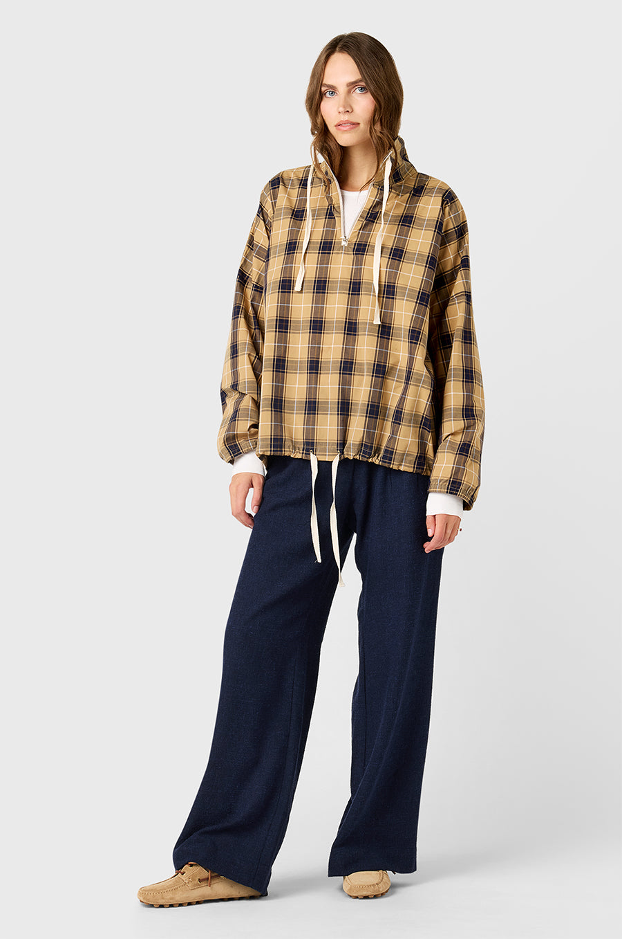 Model wearing The Lady & The Sailor Anorak in Camel Plaid - a quarter zip anorak with a tall collar and relaxed fit.