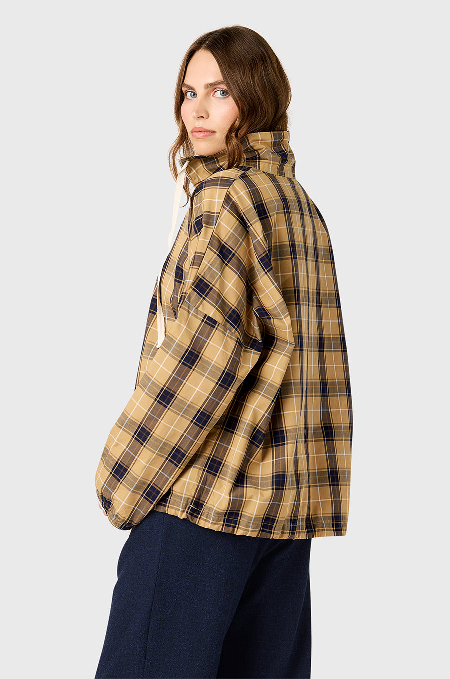 Model wearing The Lady & The Sailor Anorak in Camel Plaid - a quarter zip anorak with a tall collar and relaxed fit.