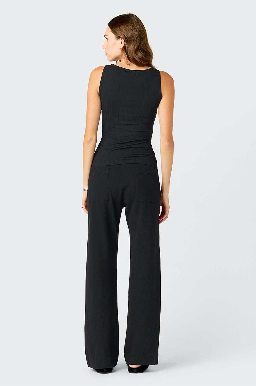 Model wearing the lady & the sailor's Pointelle Tank in Black and the the Pocket Straight Leg Pant in Black Cotton Twill.