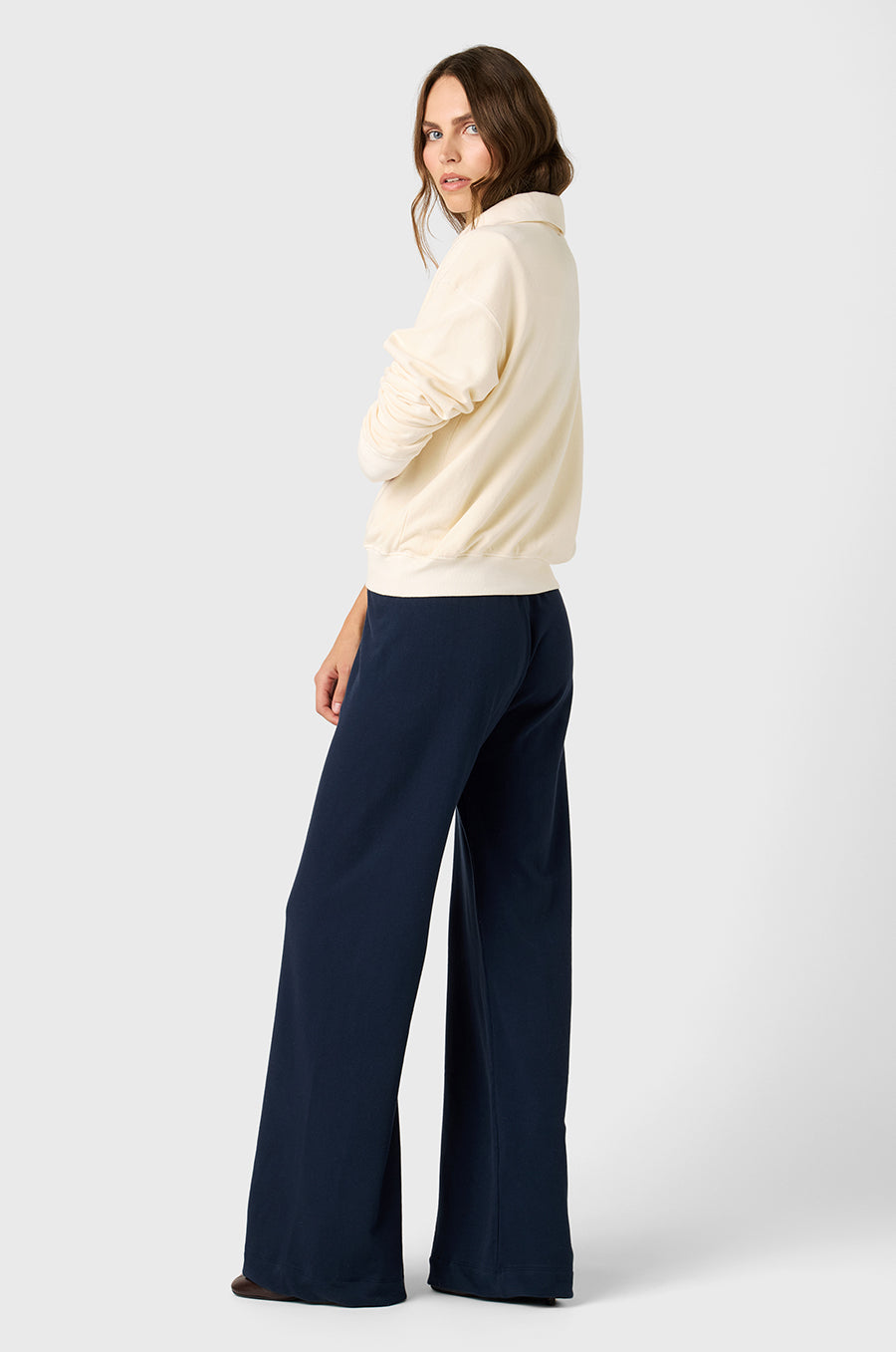 Model wearing The Lady & The Sailor Polo Sweatshirt in Vanilla Organic Cotton and the Wide Leg Pant in Deep Organic Cotton.