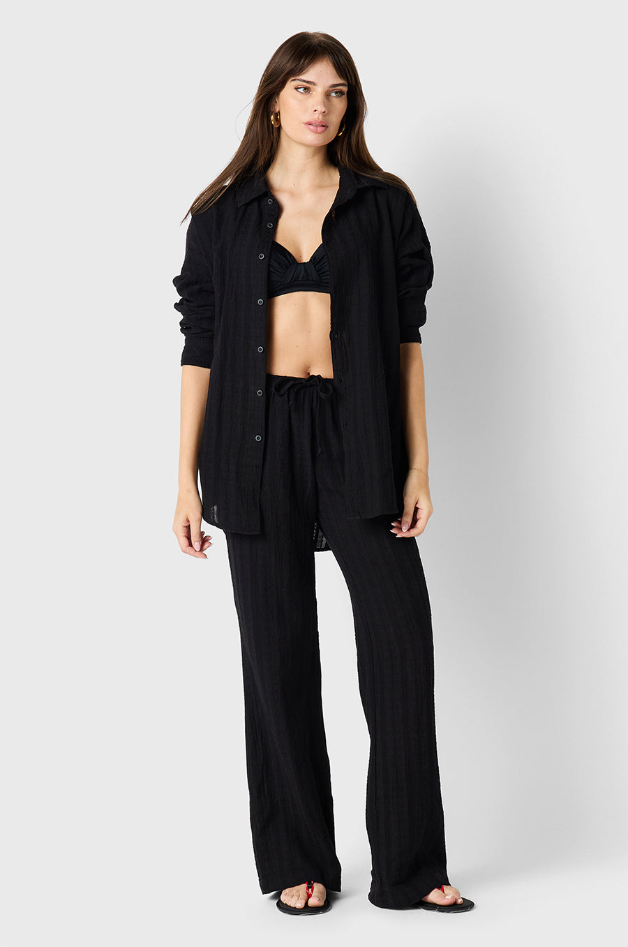 Brunette model wearing the lady & the sailor Beach Pant in Black Beach Stripe
