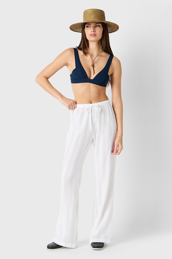 Brunette model wearing the lady & the sailor Beach Pant in White Beach Stripe