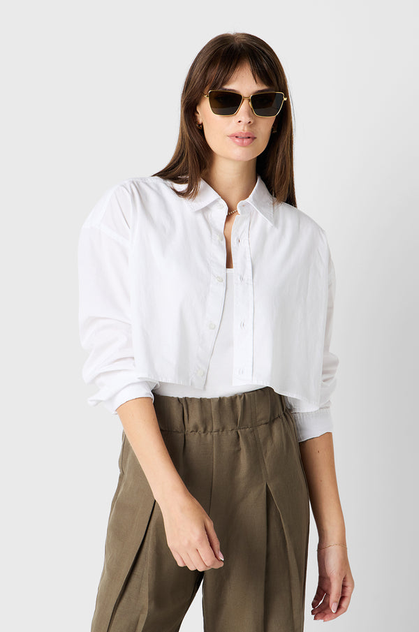 Brunette model wearing the lady & the sailor Cropped Button Up in White Poplin.