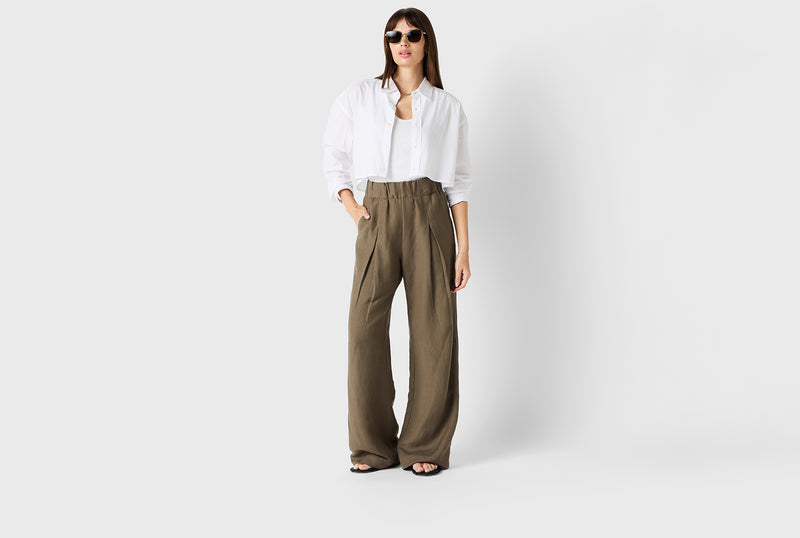 Brunette Model wearing the lady & the sailor Pleated Trouser in Moss