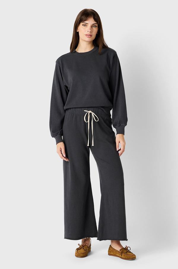 Brunette Model wearing the lady & the sailor French Flare Pant in Slate Organic Cotton