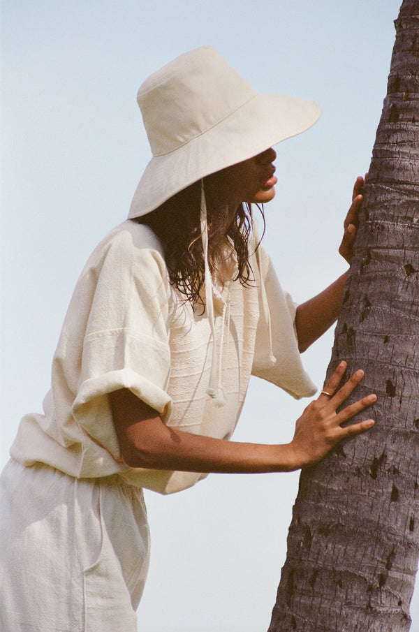 Model Wearing the Lack of Color Holiday Bucket Hat in Beige Canvas