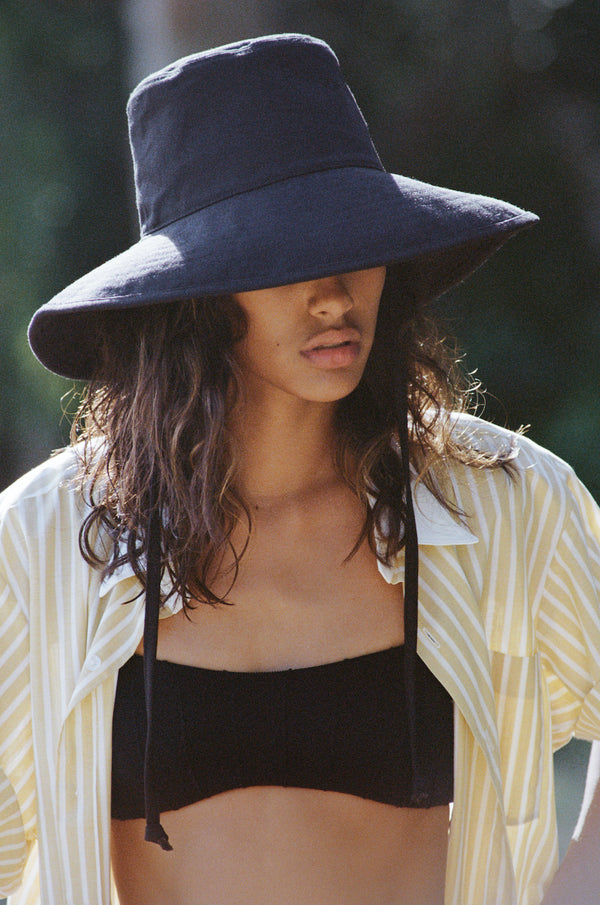 Model Wearing the Lack of Color Holiday Bucket Hat in Black Canvas